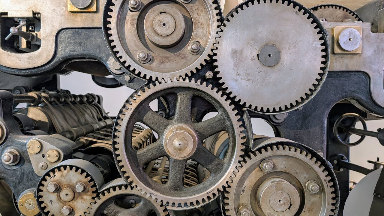Close-up view of interconnected gears in an industrial machine, showcasing engineering precision.